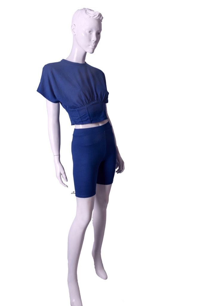 A Two-Piece Biker Short Sets featuring a corseted top and stretchy matching biker legging.