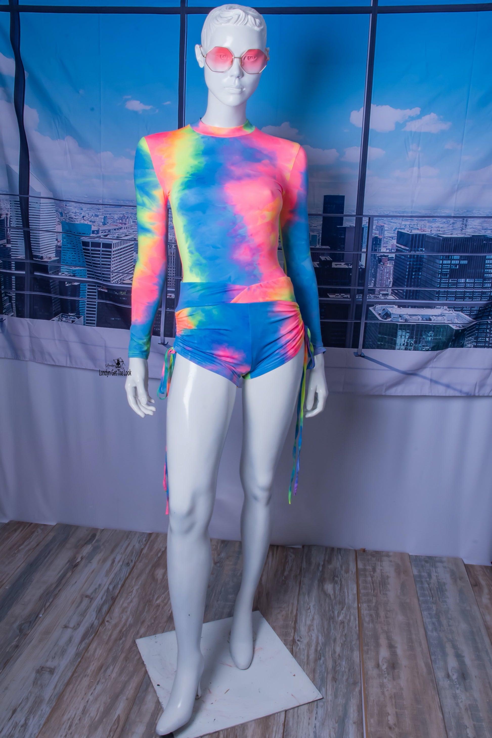 The most hottest and trendy fashion all in one outfit. Tie-Dye Bodysuit & Shorts Set, soft and comfy! Tie-Dye Featuring long sleeve bodysuit paired with drawstring side and scrunch butt booty sports shorts Detail V Neck A Combination To Die For