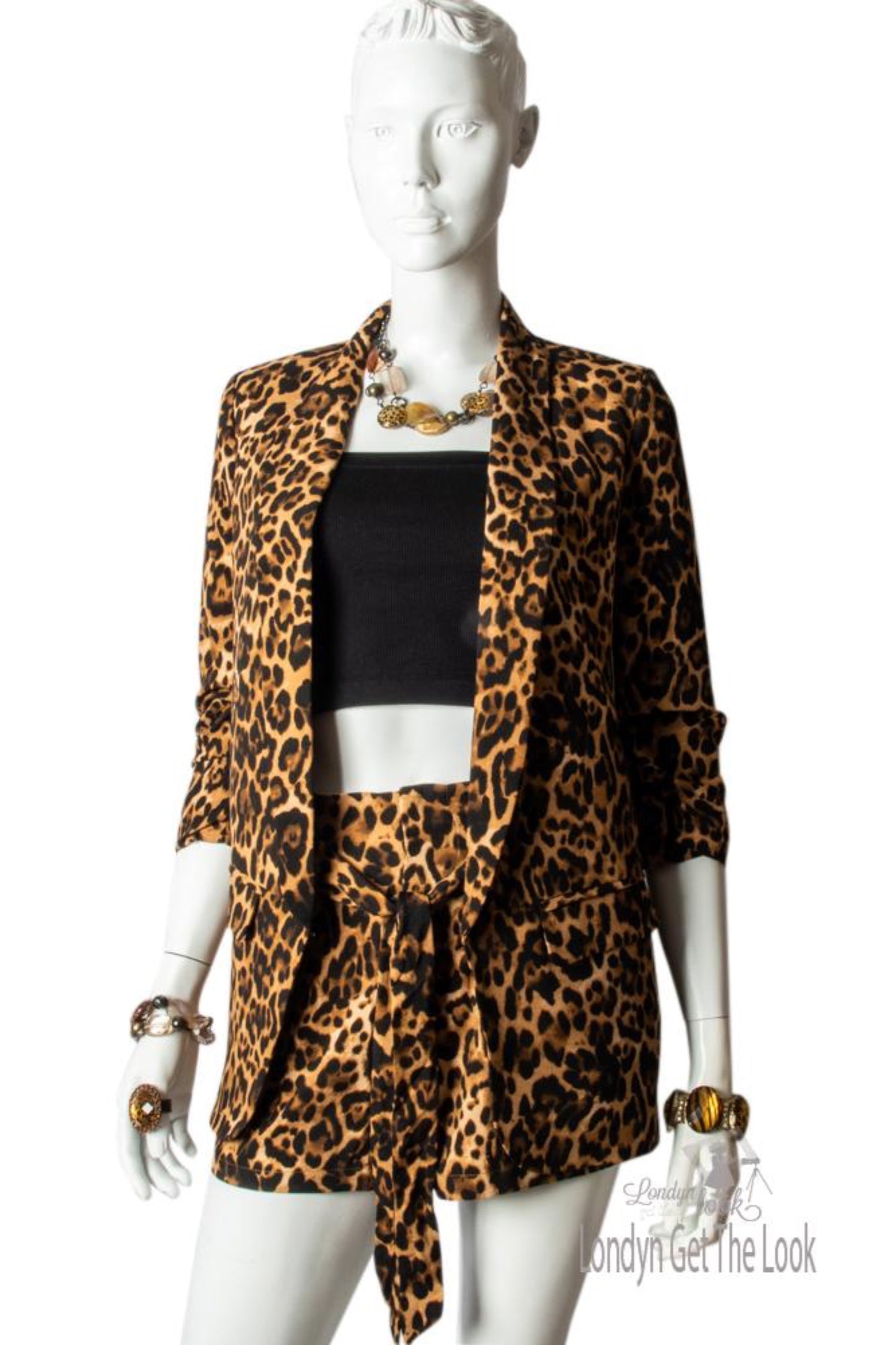 Leopard Print Blazer hip length with gathered up 3/4 sleeve has a collar side flap pockets hook to fasten or left open it also has a nice swing to it padded shoulder high rise shorts set elastic waist front zipper removable waist tie belt 2 Side slant pockets hook and eye closure 