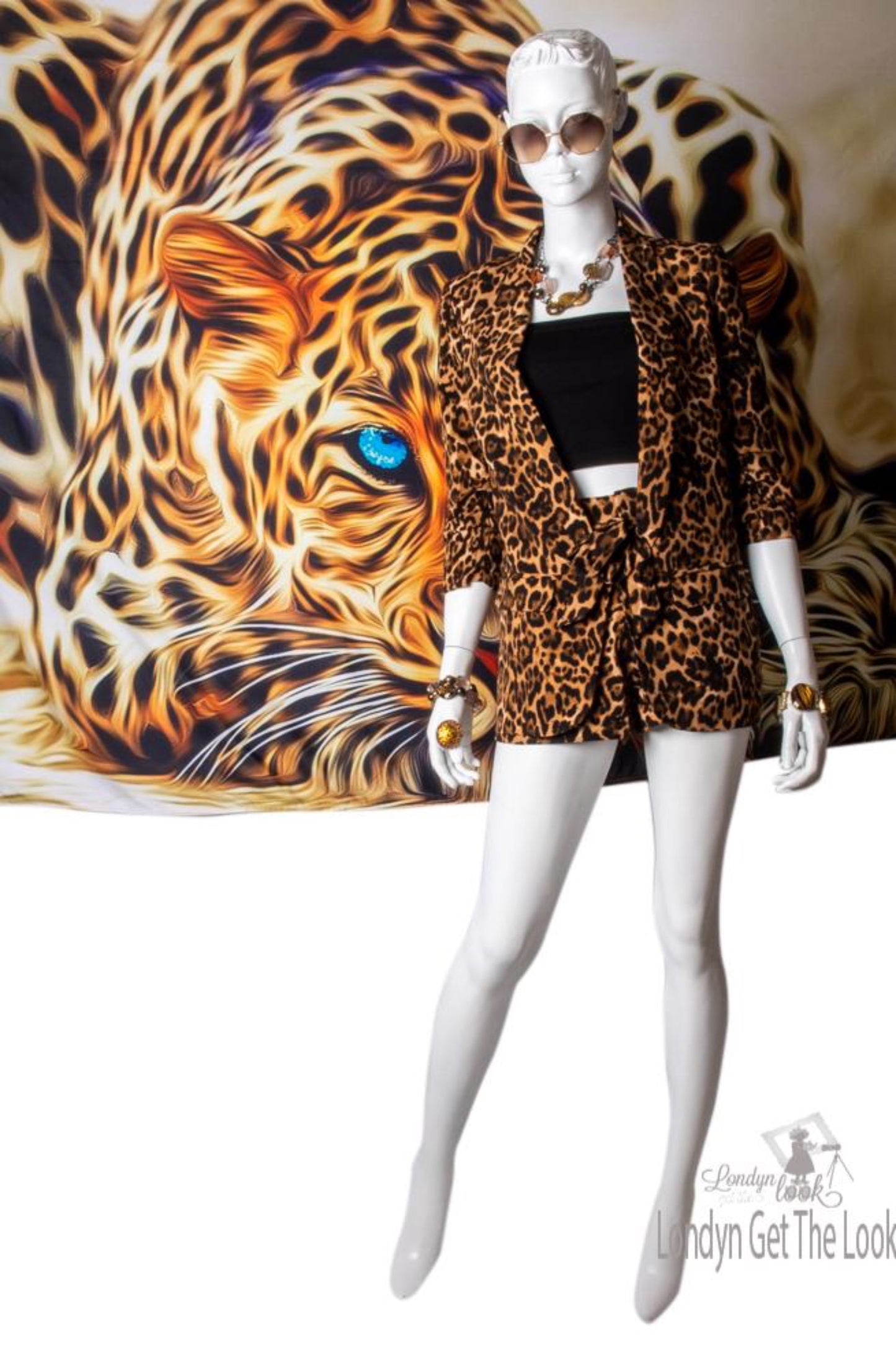 Leopard Print Blazer hip length with gathered up 3/4 sleeve has a collar side flap pockets hook to fasten or left open it also has a nice swing to it padded shoulder high rise shorts set elastic waist front zipper removable waist tie belt 2 Side slant pockets hook and eye closure 